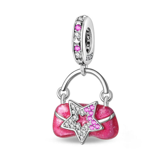 A sterling silver purse charm with pink enamel and a star-shaped zirconia design, perfect for fashionistas.