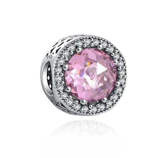 Sterling silver charm with a soft pink crystal and a cubic zirconia halo.