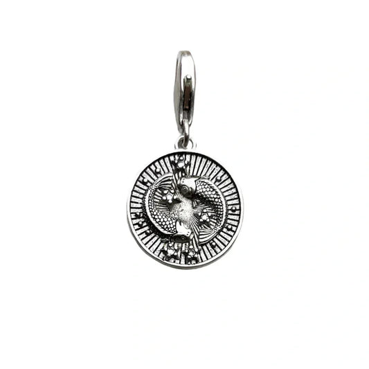 Silver pendant with intertwined snakes.