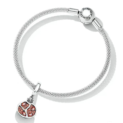 Silver charm bracelet with pomegranate pendant.