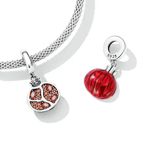 Pomegranate-themed charm pendants.