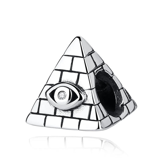 Silver pyramid-shaped charm with engraved brick detailing and an All-Seeing Eye set with a clear cubic zirconia crystal, with a threading hole on the side for attaching to a charm bracelet
