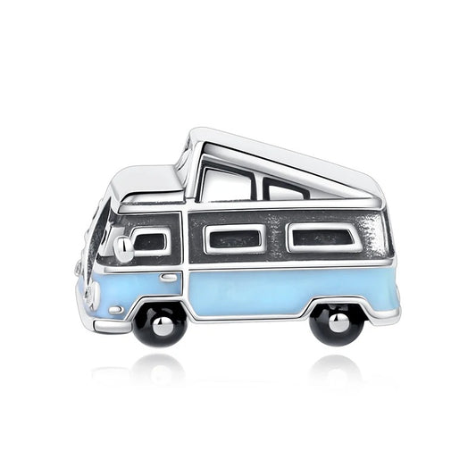 A silver clip-on charm shaped like a retro camper van with sky-blue enamel lower body, black enamel wheels, pop-top roof, and side window details