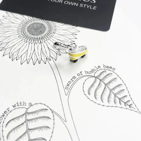 Silver and yellow roller skate charm.