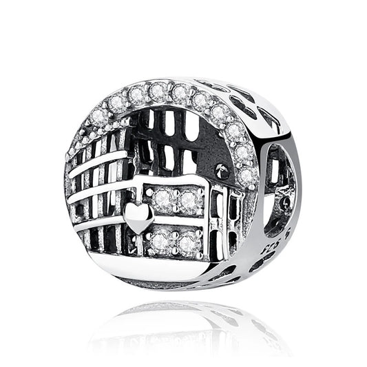 A sterling silver Roman Colosseum arch charm with openwork architectural details, a small heart motif, and clear cubic zirconia crystal accents along the arch and center panel.