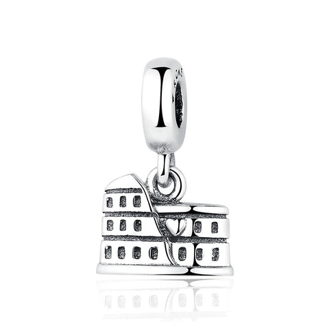 A silver dangle charm shaped like the Roman Colosseum with tiered arched levels and oxidized detailing, suspended from a polished clip bail
