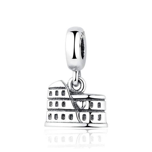 A silver dangle charm shaped like the Roman Colosseum with tiered arched levels and oxidized detailing, suspended from a polished clip bail