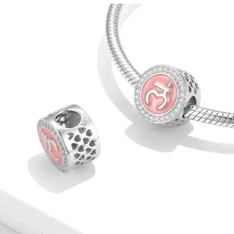 Silver charm bracelet with pink Om symbol.