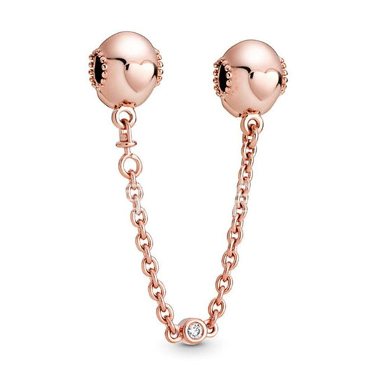 Rose gold ear chains with heart and CZ details
