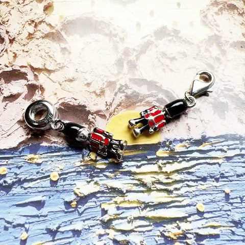 Two silver and red soldier charms.