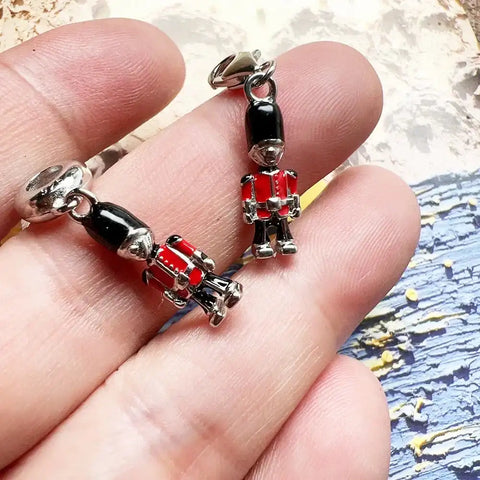 Two British soldier charm pendants.