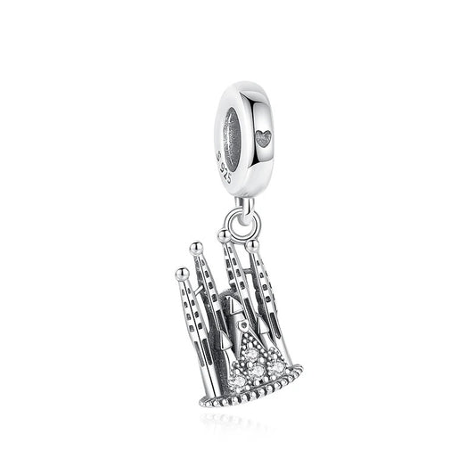A silver dangle charm shaped like a Gothic cathedral with tall spires and clear cubic zirconia stones at the base, attached to a clip-on bail engraved with a small heart, shown on a white background