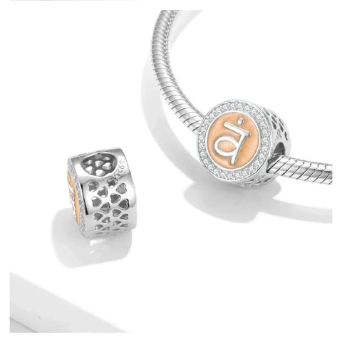 Silver and peach charm bracelet beads.