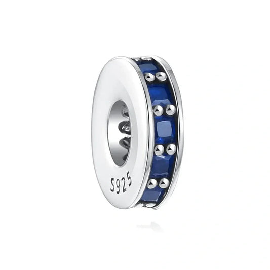 Sterling silver spacer charm with sapphire blue cubic zirconia stones for a timeless and elegant look.