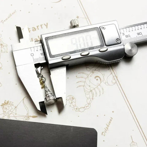 Digital caliper measuring a pendant.