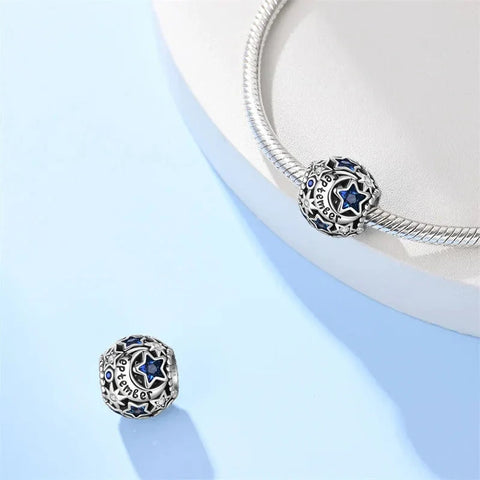 Silver charm with blue stars and 'September' inscription.