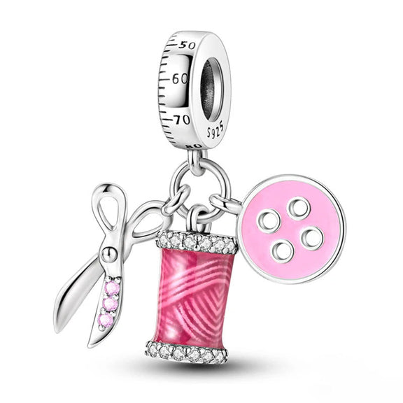 Silver Sewing Charm - Silver sewing charm with pink enamel scissors and thread.