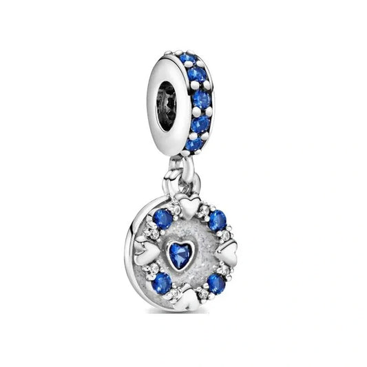 Star-shaped sterling silver charm with blue crystals, adding sparkle and magic to any jewelry collection.