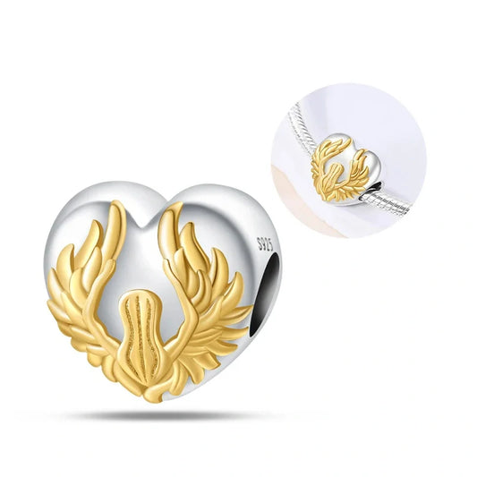 Sterling silver heart-shaped charm featuring golden angel wings, symbolizing love, protection, and divine guidance.