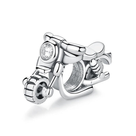 Silver Motorcycle Scooter Clip-On Charm with Crystal Headlight - A silver-toned motorcycle scooter charm with detailed tyre tread, handlebars, a polished seat, and a round clear crystal set into the front headlight, photographed on a white background.