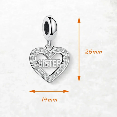 Silver heart-shaped charm with 'sister' inscription.