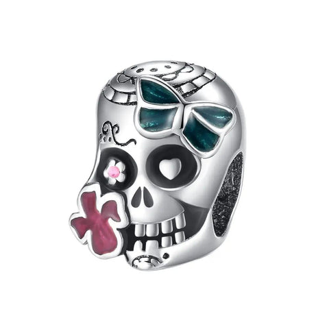 Skull charm with green bow and red flower detail, designed for bracelets, featuring whimsical and edgy design elements.