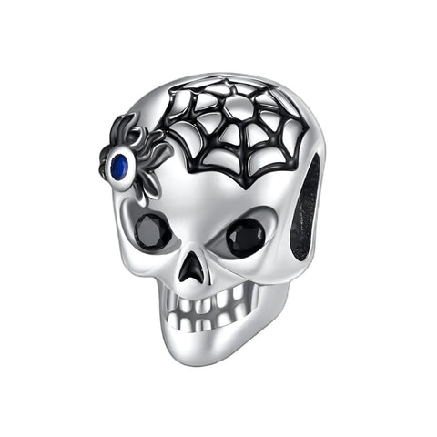 Skull Charm with Spiderweb and Blue Gem Spider Accent for Spooky Style - Skull charm featuring a spiderweb with a blue gem spider accent, perfect for gothic-inspired jewelry styles.