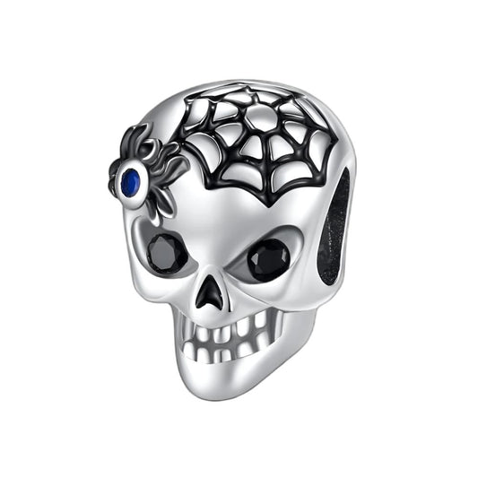 Skull charm featuring a spiderweb with a blue gem spider accent, perfect for gothic-inspired jewelry styles.
