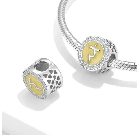 Silver and yellow chakra charm.