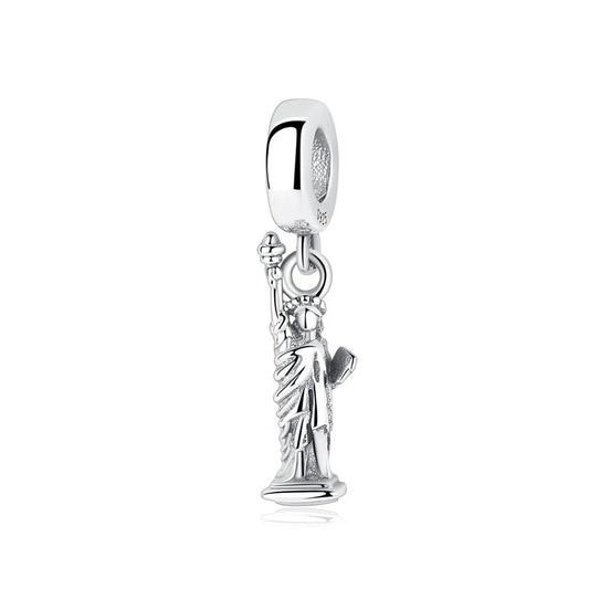 A sterling silver dangle charm shaped like the Statue of Liberty, with raised torch and flowing robes, hanging from a smooth S925 bail bead