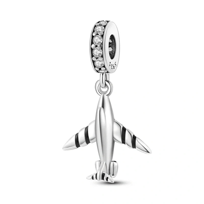 Sterling silver airplane charm with cubic zirconia accents, ideal for travel lovers or aviation enthusiasts.