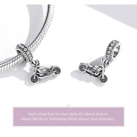 Exquisite Sterling Silver Harley-Davidson Motorcycle Charm for Enthusiasts - Two sterling silver Harley-Davidson motorcycle charms, one attached to a bracelet and the other resting on a flat surface, highlighting their intricate design.