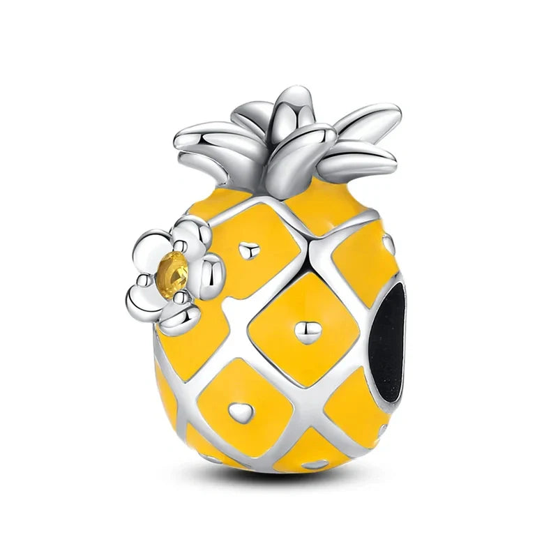 Sterling silver pineapple charm with bright yellow enamel and a small flower detail, perfect for tropical-themed jewelry.