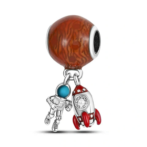 Sterling silver astronaut and rocket charm with marbled brown enamel planet, ideal for space lovers and explorers.