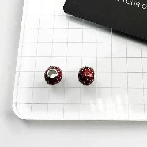 Two red, textured beads.