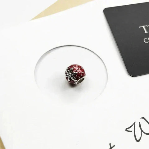 Red and silver charm bead.