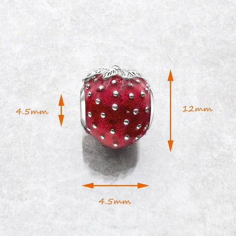 Red strawberry charm with silver accents.