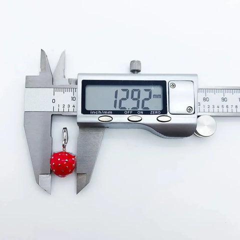 Red strawberry charm.