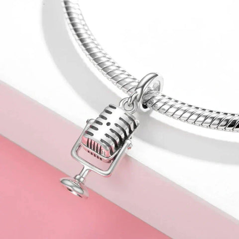 Silver microphone charm.