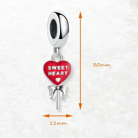 Heart-shaped lollipop charm.