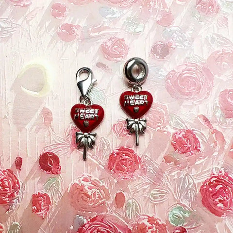 Two red heart-shaped charms.
