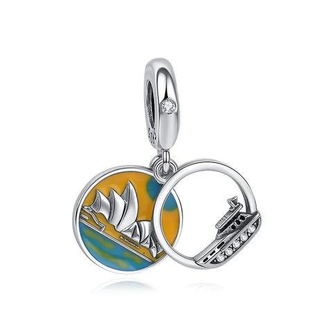 Sydney Opera House & Harbour Bridge Travel Charm - Silver charm pendant featuring a colourful enamel disc with the Sydney Opera House on an orange and teal background, paired with a circular Sydney Harbour Bridge charm set with clear cubic zirconia stones