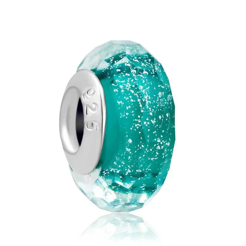 Sterling silver charm with a bold teal faceted crystal for vibrant color and sparkle.