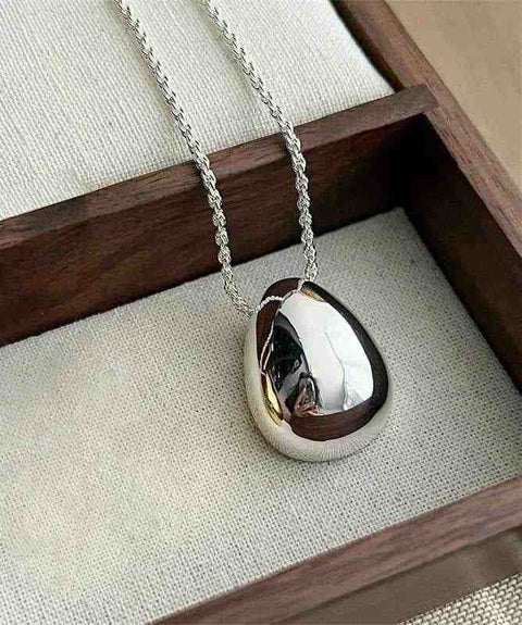 Chic Gold and Silver Teardrop Pendants for Every Occasion - a silver locked with a black and white photo inside