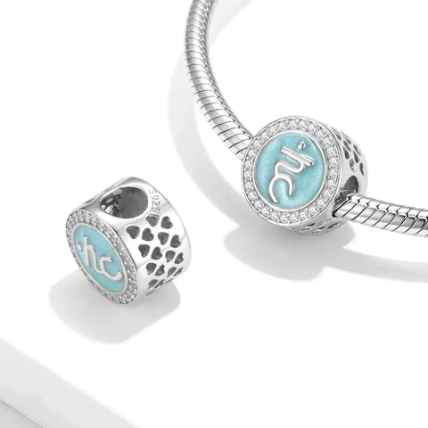 Silver charm bracelet with light blue accents.