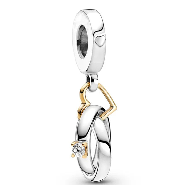 Two-Tone Wedding Rings Dangle Charm - Elegant wedding ring charm in two-tone, ideal for commemorating love.