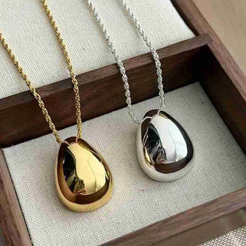 Chic Gold and Silver Teardrop Pendants for Every Occasion - a gold and silver tear necklace with a black tear tear