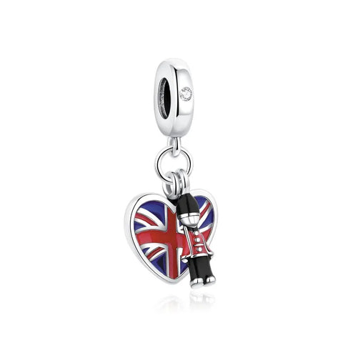 Union Jack Heart & Royal Guard Dangle Charm - A silver clip-on charm featuring a heart-shaped Union Jack enamel pendant and a miniature Royal Guard figure dangle charm on a white background