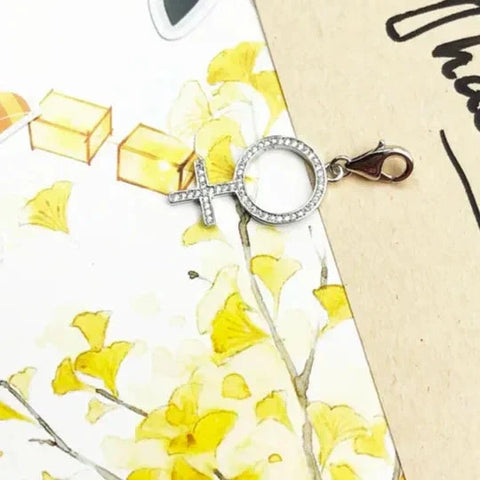 Silver-colored female symbol charm with lobster clasp.