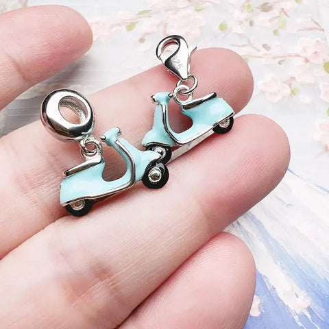 Two light blue scooter charms.